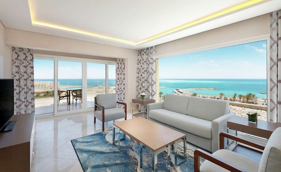 Suite, 1 King Bed, Kitchenette, Sea View (Blue Bay) | Living area | 55-inch Smart TV with satellite channels, TV
