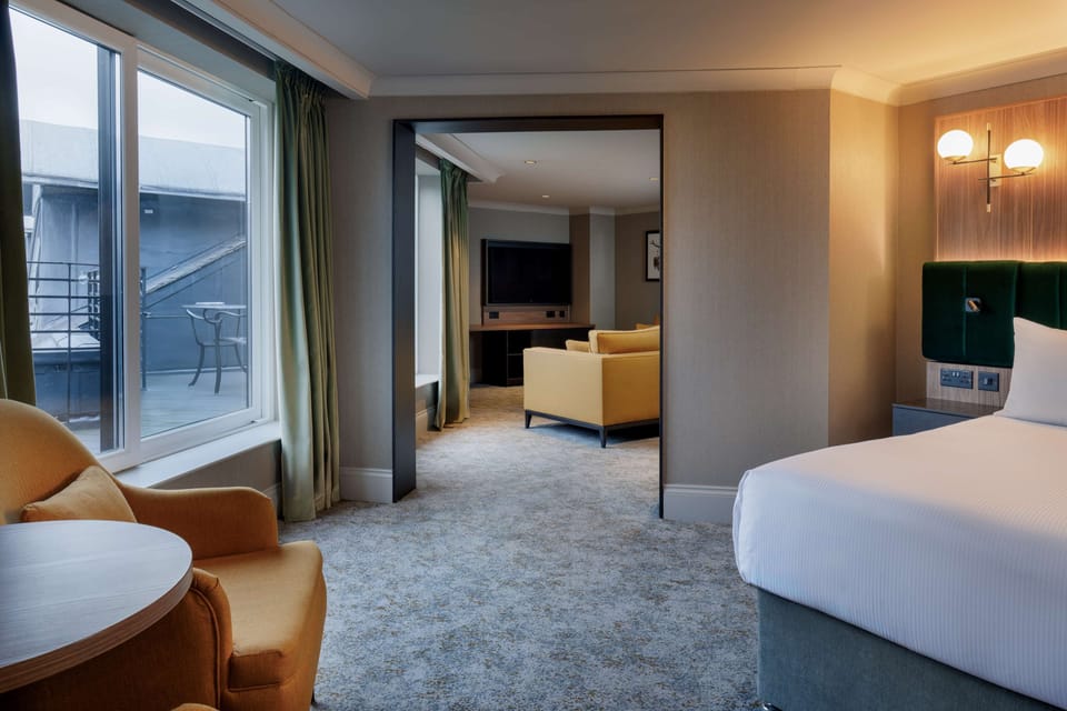 Deluxe Suite, 1 King Bed | In-room safe, desk, laptop workspace, blackout drapes