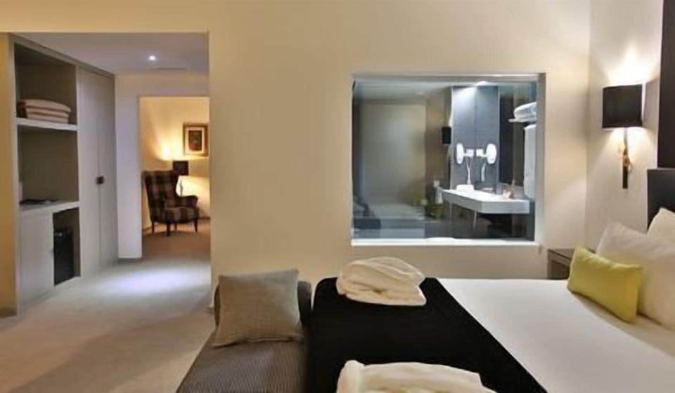 Deluxe Suite, River View | Minibar, in-room safe, desk, blackout drapes