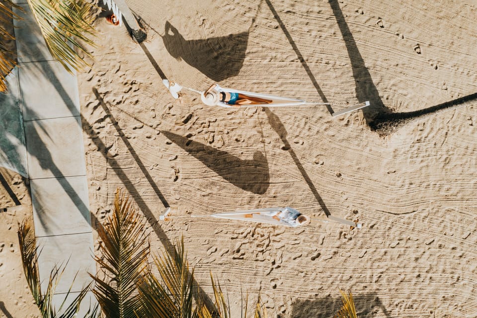 On the beach, white sand, beach towels, beach massages