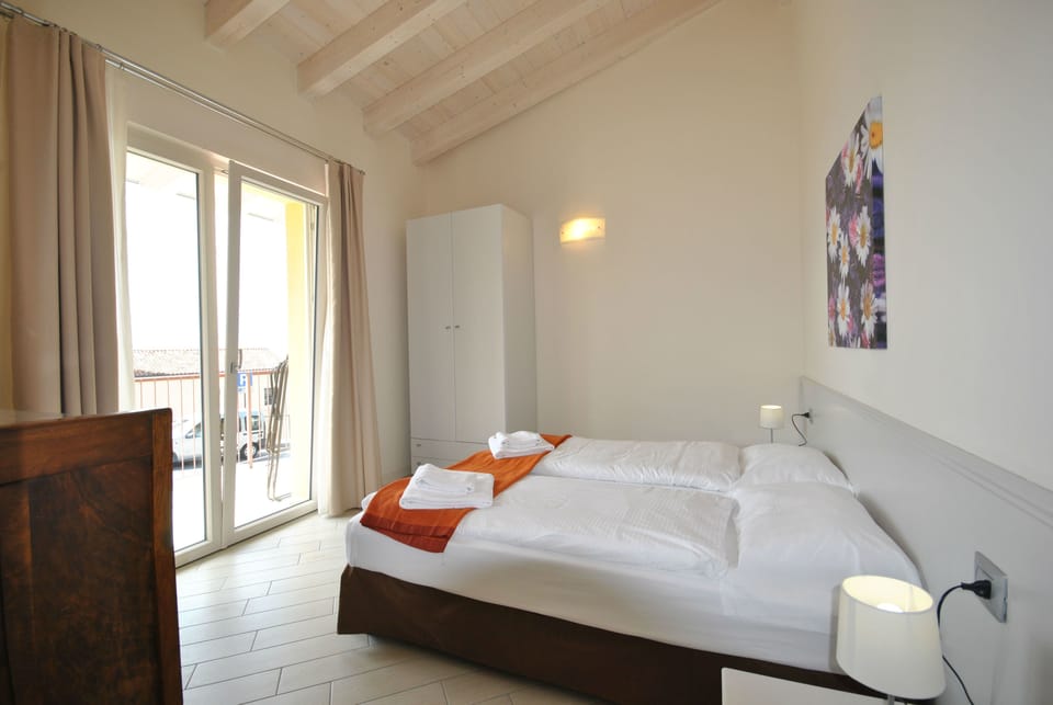 Standard Apartment, Lake View | Down comforters, in-room safe, desk, free WiFi