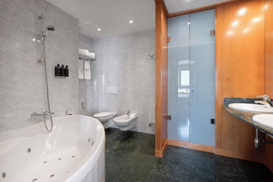 Bathtub, eco-friendly toiletries, hair dryer, bidet