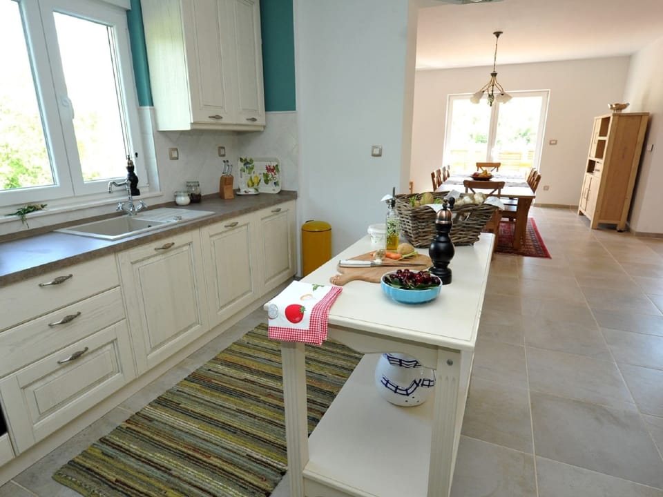 Villa | Private kitchen | Stovetop, dishwasher, highchair, cookware/dishes/utensils