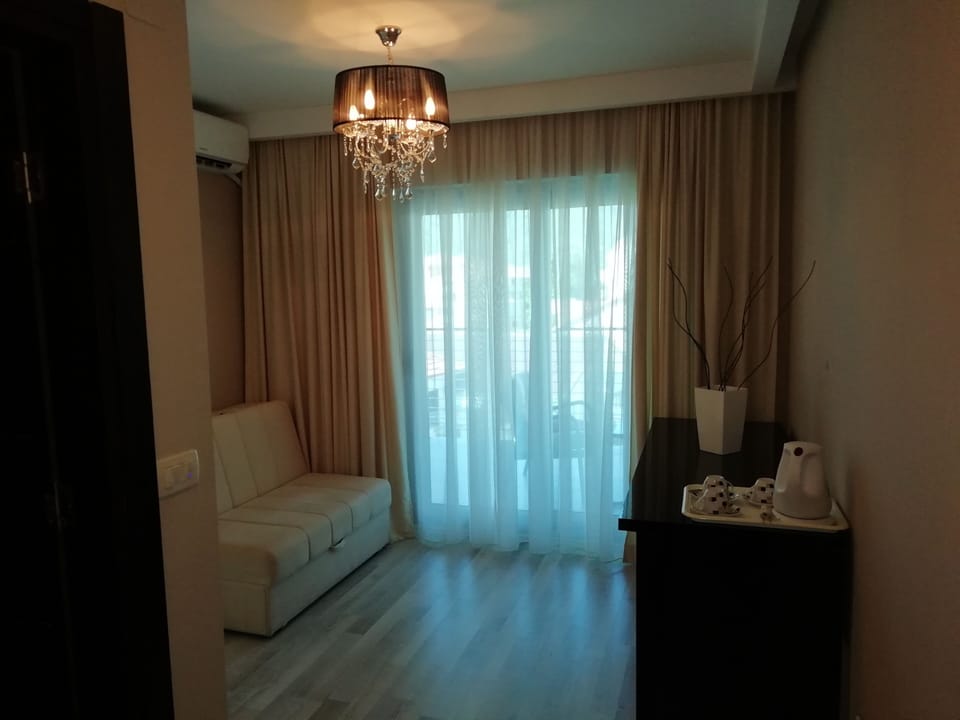 Deluxe Triple Room | Living area | LCD TV