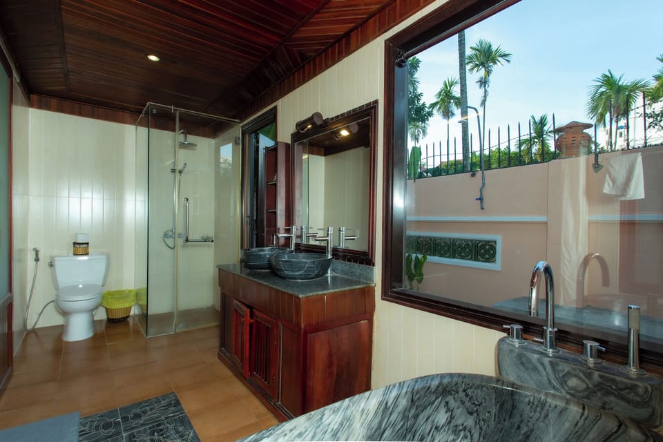 Villa, 1 King Bed, Garden Area | Bathroom | Combined shower/tub, free toiletries, towels