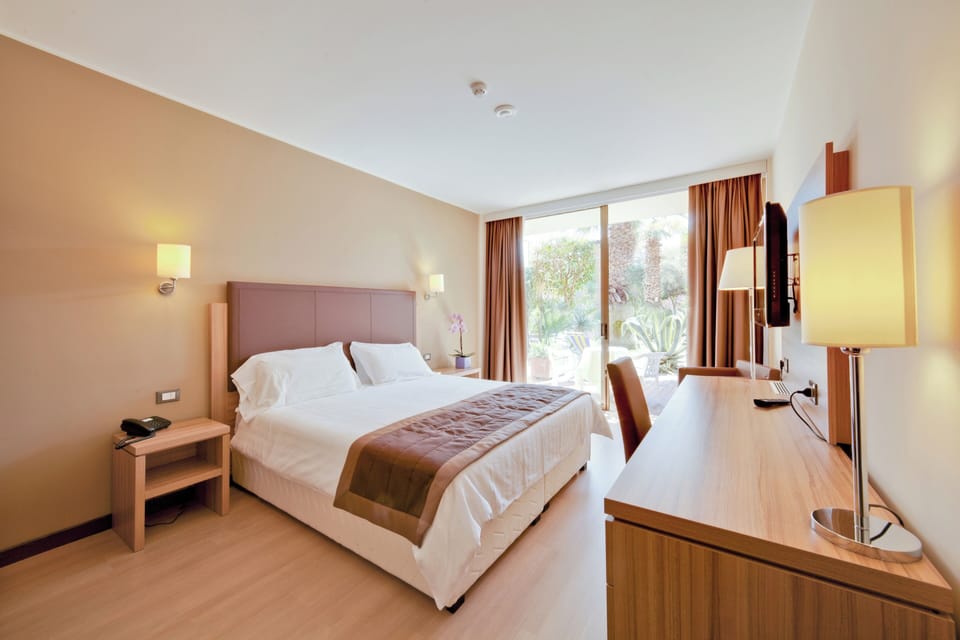 Comfort Room, Patio, Annex Building (Jazz) | Minibar, in-room safe, desk, soundproofing