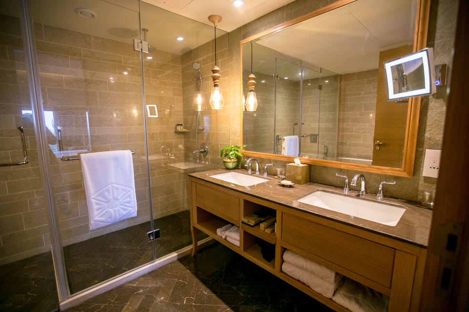 Shower, designer toiletries, hair dryer, slippers