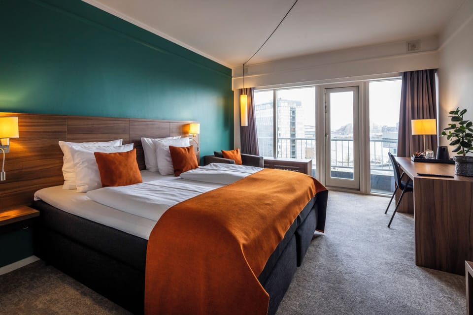 Premium bedding, desk, laptop workspace, iron/ironing board