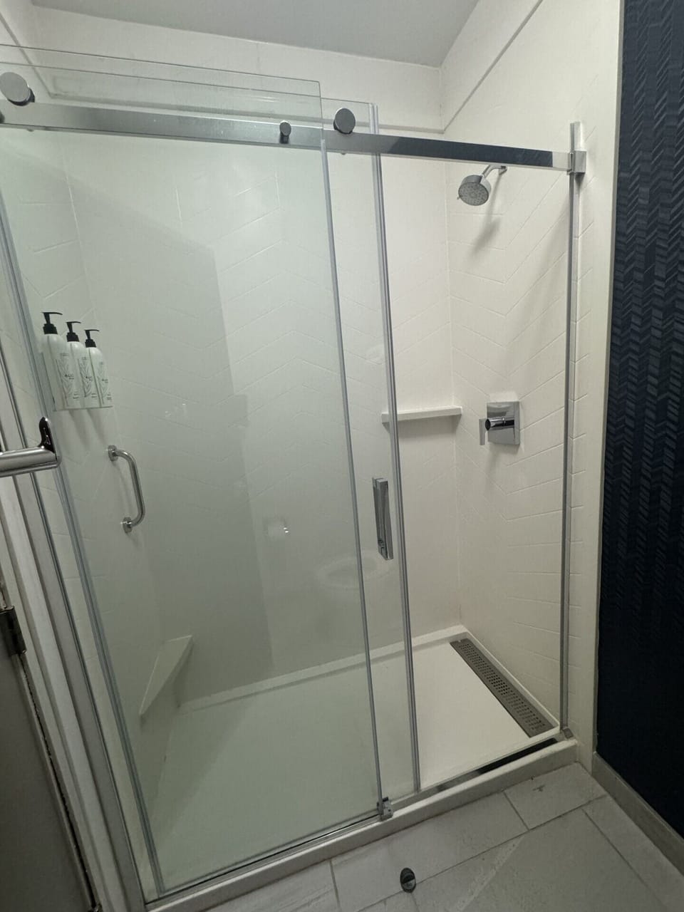 Shower, designer toiletries, hair dryer, towels