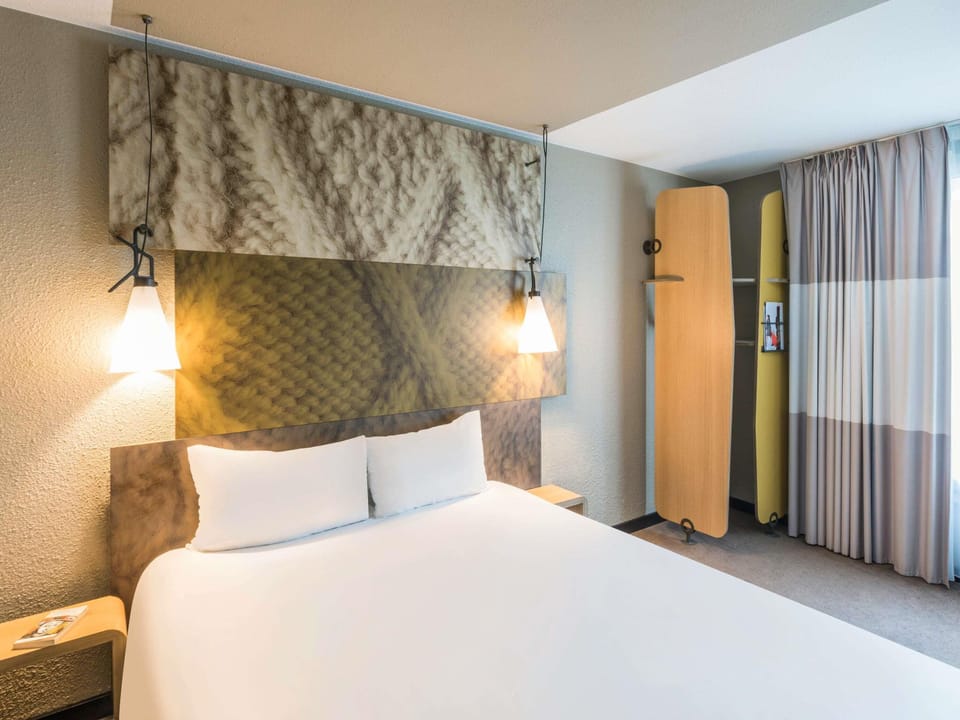 Hypo-allergenic bedding, desk, laptop workspace, blackout drapes