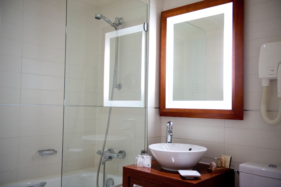 Designer toiletries, hair dryer, slippers, towels