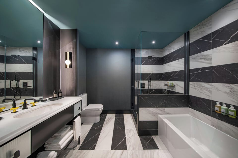 Suite, 1 King Bed | Bathroom | Combined shower/tub, rainfall showerhead, free toiletries, hair dryer