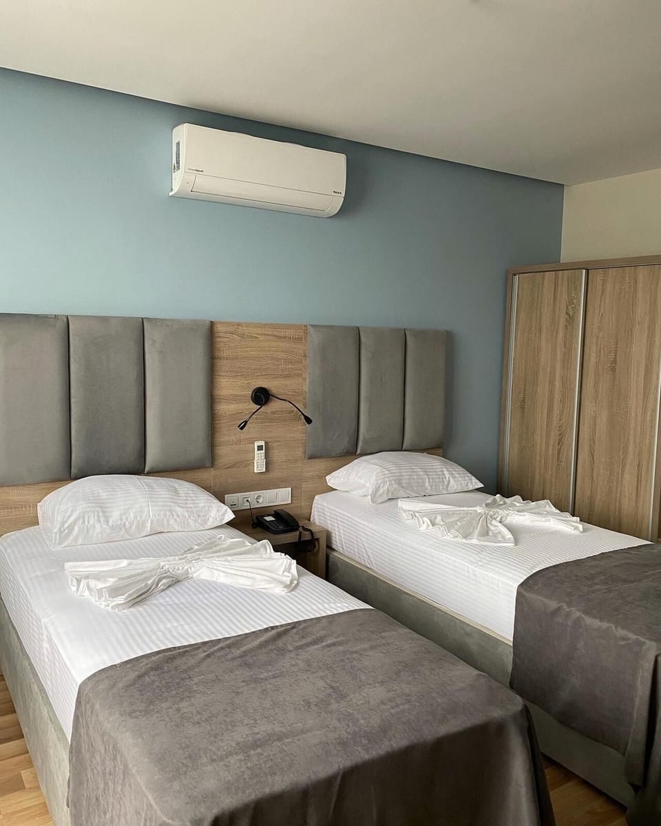 Deluxe Twin Room, Sea View | Minibar, in-room safe, desk, blackout drapes