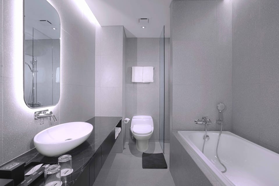 Junior Room | Bathroom | Shower, hair dryer, slippers, towels