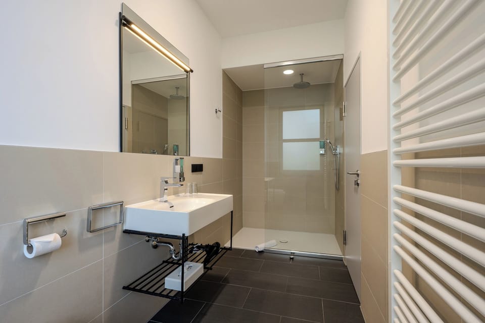 Superior French Room | Bathroom | Shower, rainfall showerhead, hair dryer, towels