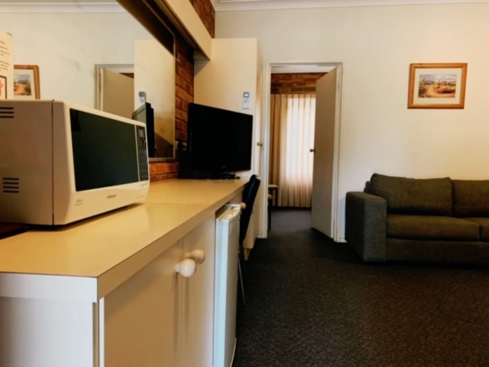 Desk, laptop workspace, blackout drapes, iron/ironing board