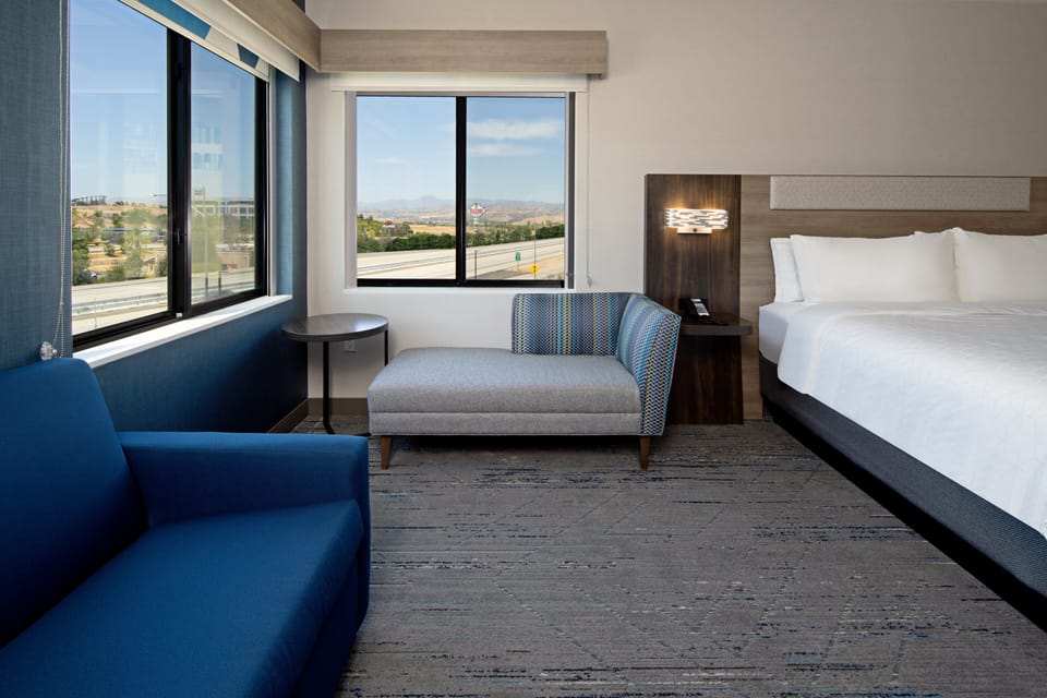 Premium bedding, desk, laptop workspace, blackout drapes