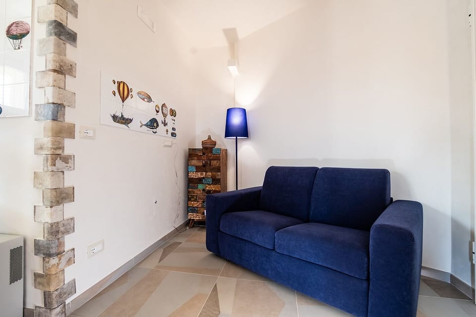 Deluxe Triple Room | Living area | Flat-screen TV