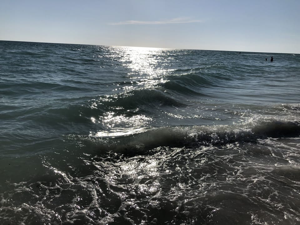 Beach nearby, white sand, beach umbrellas, beach towels