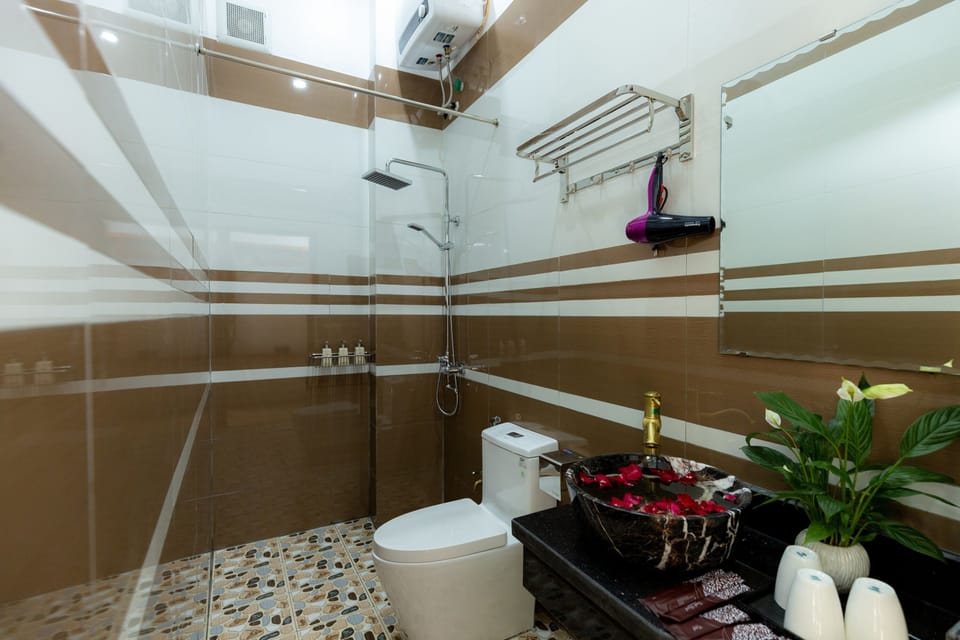 Shower, hair dryer, slippers, towels