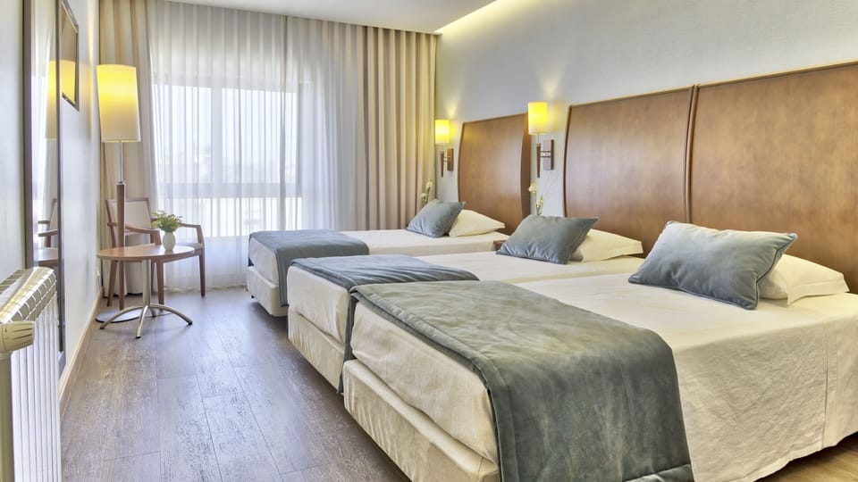 Triple Room | Minibar, in-room safe, individually furnished, desk