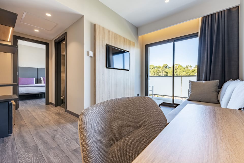 Family Room with City View and Window | Down comforters, minibar, desk, blackout drapes