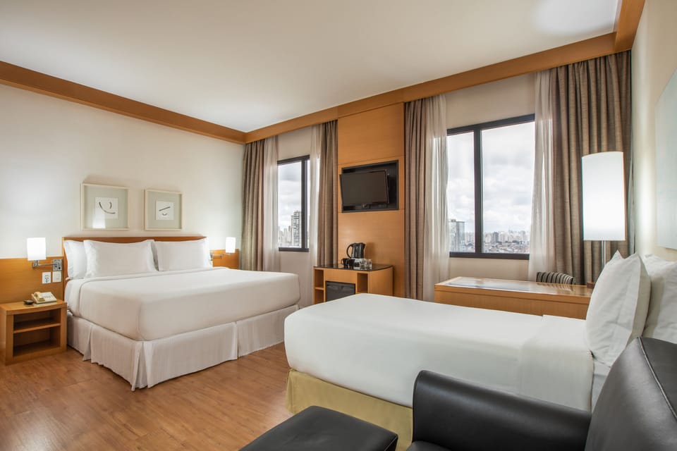 Premium Triple Room (QUEEN) | Minibar, in-room safe, desk, laptop workspace