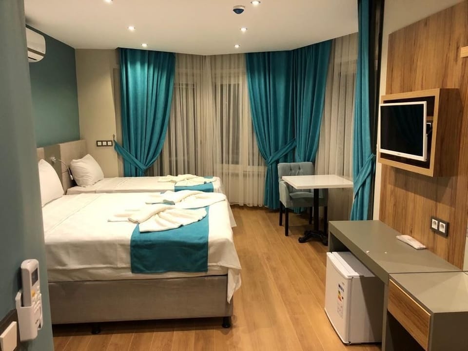 Family Triple Room | Minibar, laptop workspace, WiFi (free), individually decorated