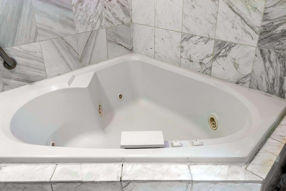 Suite, 1 King Bed, Jetted Tub | In-room safe, iron/ironing board, travel crib, rollaway beds