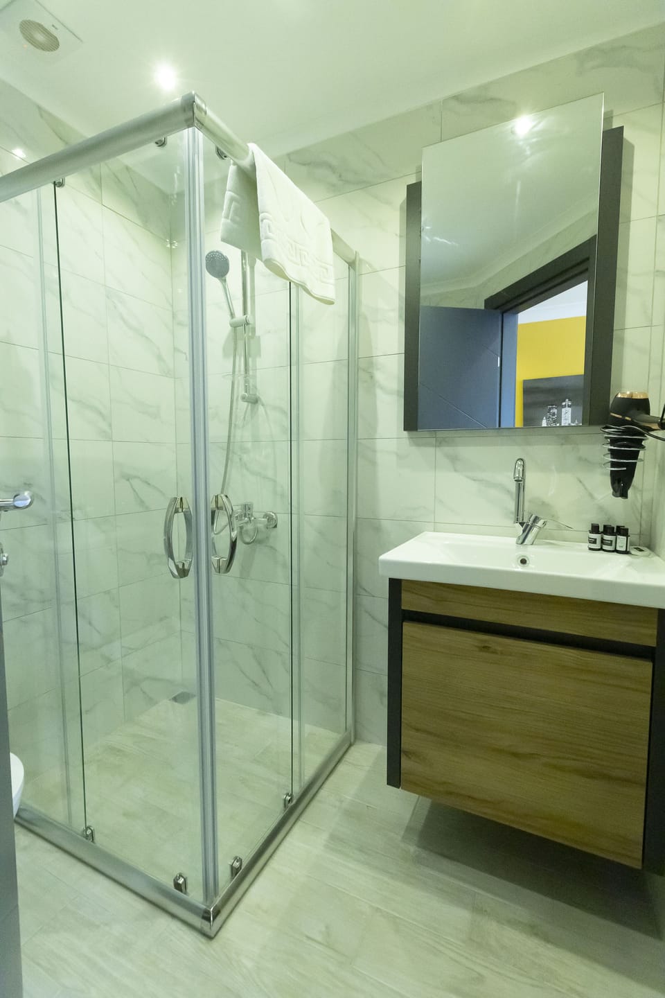 Shower, hair dryer, slippers, towels