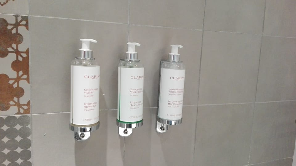 Combined shower/tub, designer toiletries, hair dryer, bathrobes