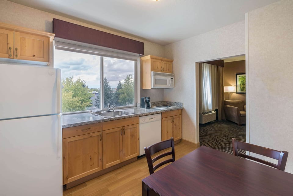Premium bedding, desk, laptop workspace, blackout drapes