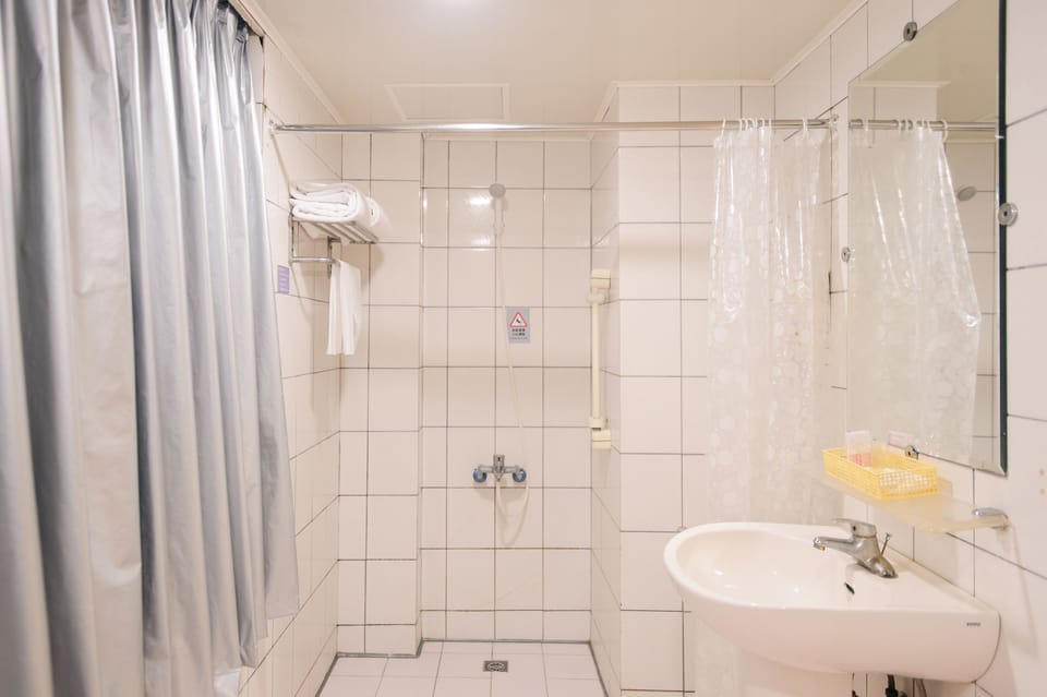 Shower, hair dryer, slippers, towels