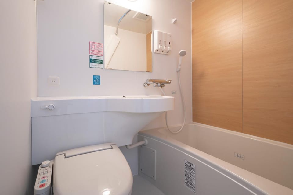 Combined shower/tub, free toiletries, hair dryer, slippers