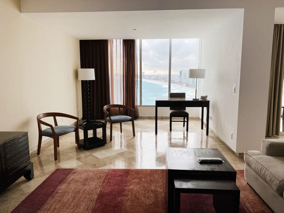 Presidential Room, 1 King Bed, Ocean View | Living area | 50-inch LED TV with cable channels, TV, books
