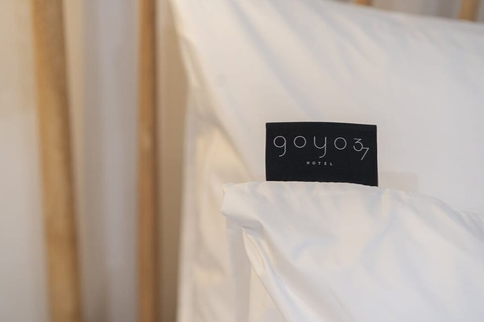 Premium bedding, desk, laptop workspace, soundproofing