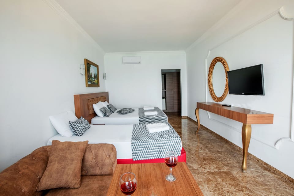 Triple Room, Partial Sea View | Minibar, in-room safe, soundproofing, WiFi (free)