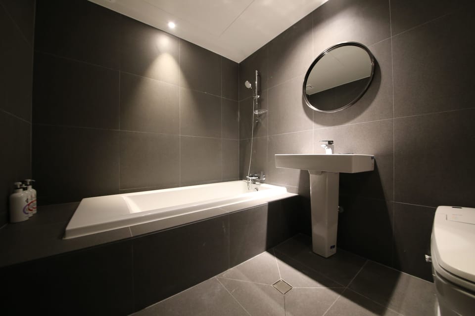 Deluxe Room | Bathroom | Hair dryer, slippers, towels, soap