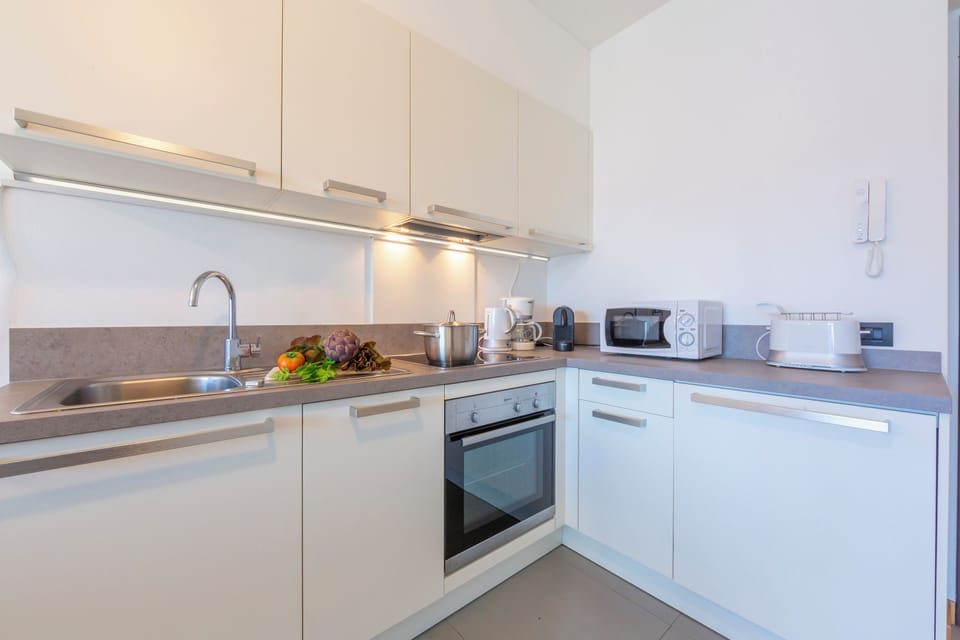 Family Apartment, 2 Bedrooms, Microwave, Mountainside (Residence degli Oleandri 2A) | Private kitchen | Coffee/tea maker, microwave, oven, stovetop