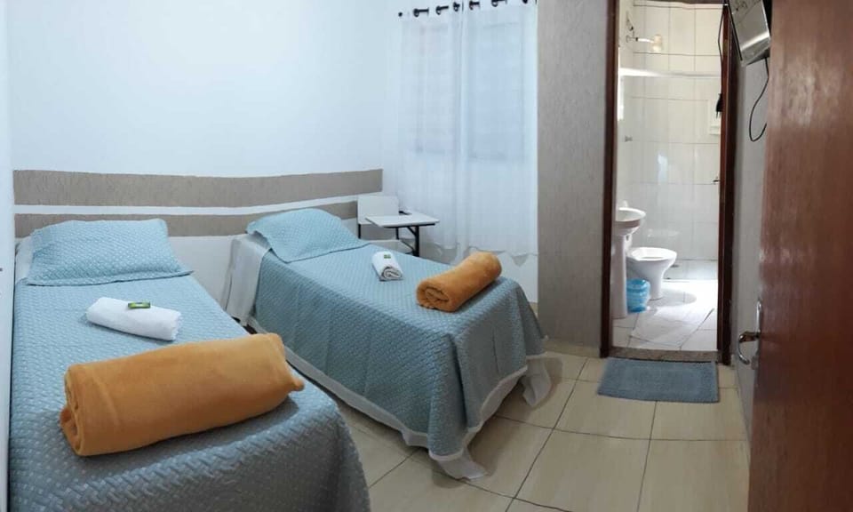 Economy Twin Room | Minibar, desk, WiFi (free), bed sheets