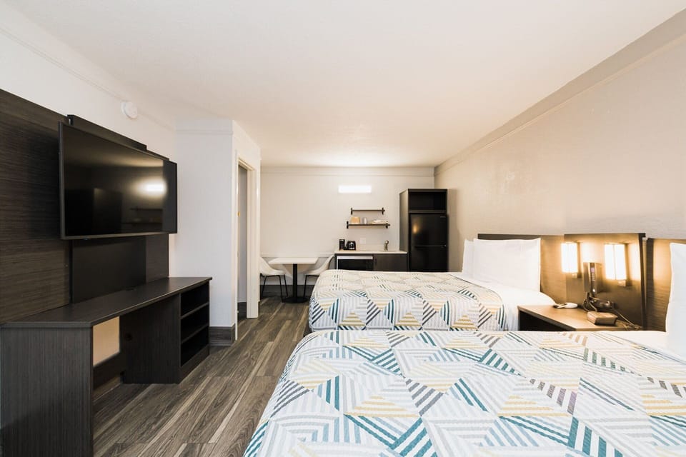 Premium bedding, desk, laptop workspace, blackout drapes