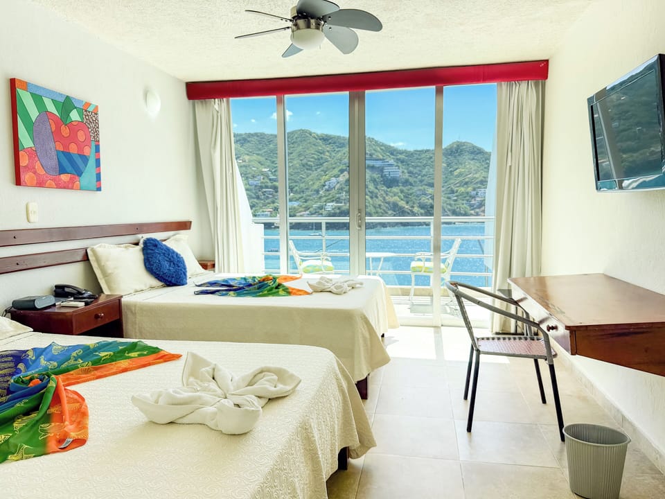 Deluxe Quadruple Room, Sea View | In-room safe, blackout drapes, WiFi (free), bed sheets