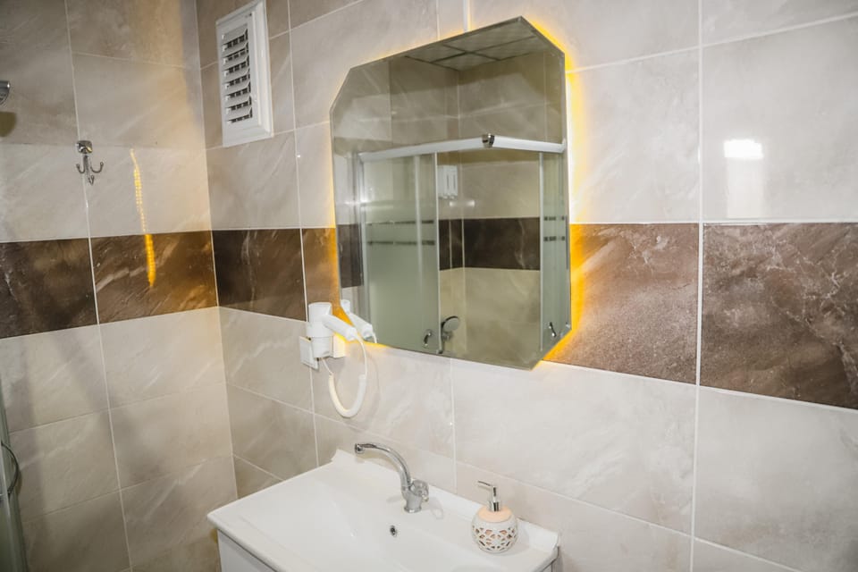 Shower, hair dryer, slippers, towels
