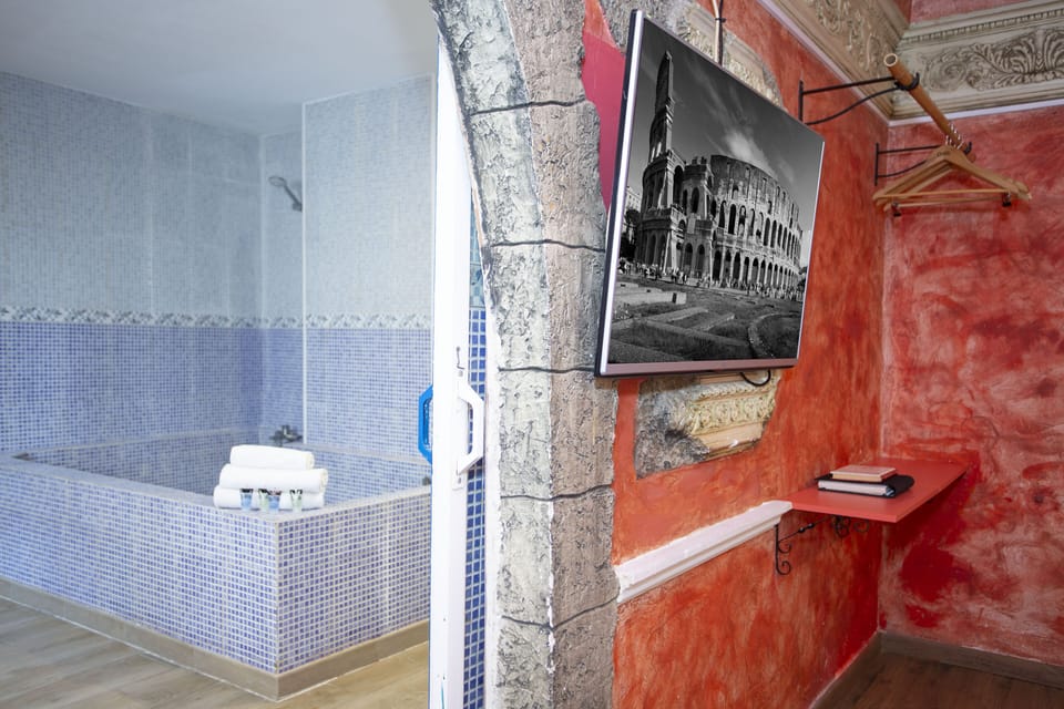 Luxury Suite, Hot Tub | Bathroom | Hair dryer, towels, soap, shampoo