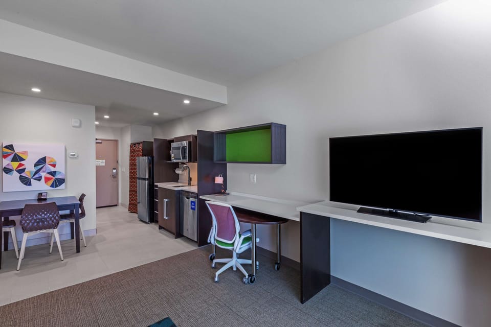 Premium bedding, desk, laptop workspace, blackout drapes