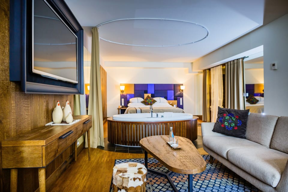 Senior Suite | Living area | 40-inch LCD TV with cable channels, TV