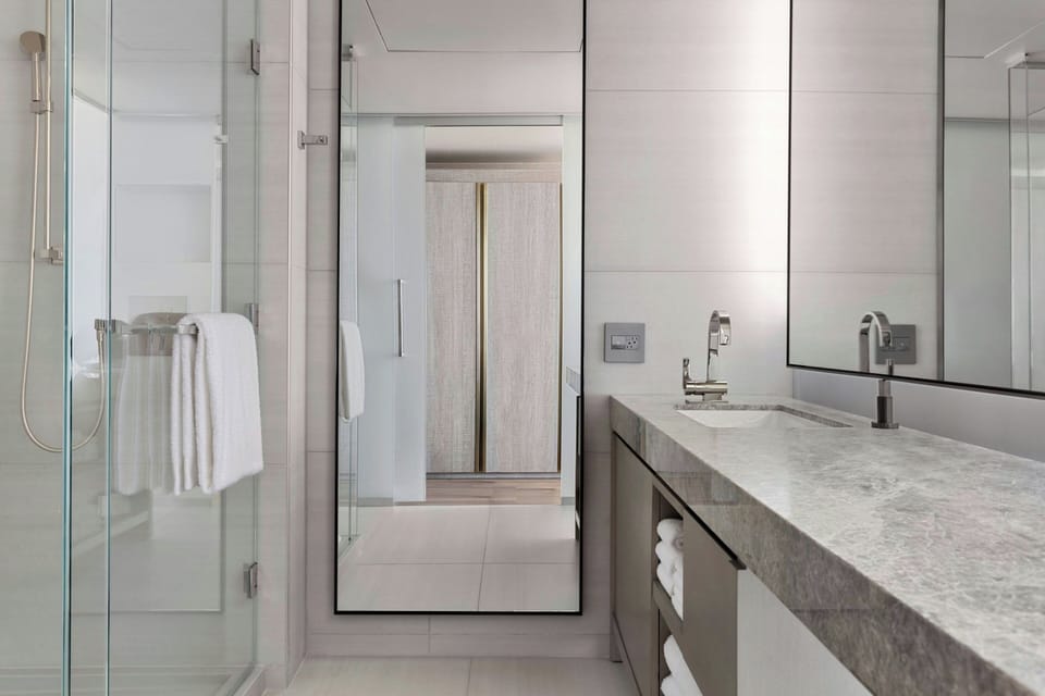 Shower, designer toiletries, hair dryer, towels
