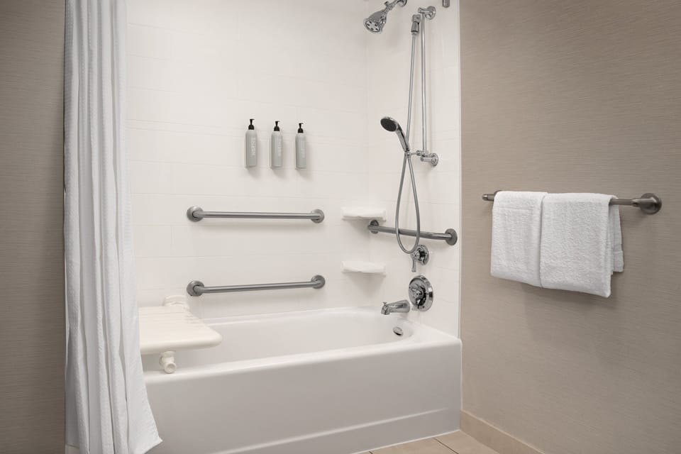 Combined shower/tub, designer toiletries, hair dryer, towels