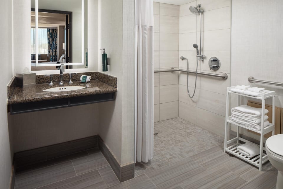 Combined shower/tub, designer toiletries, hair dryer, towels