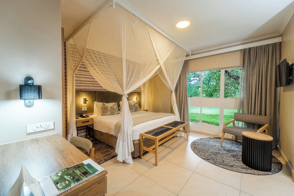 Suite, 1 King Bed, Garden View | In-room safe, desk, laptop workspace, blackout drapes